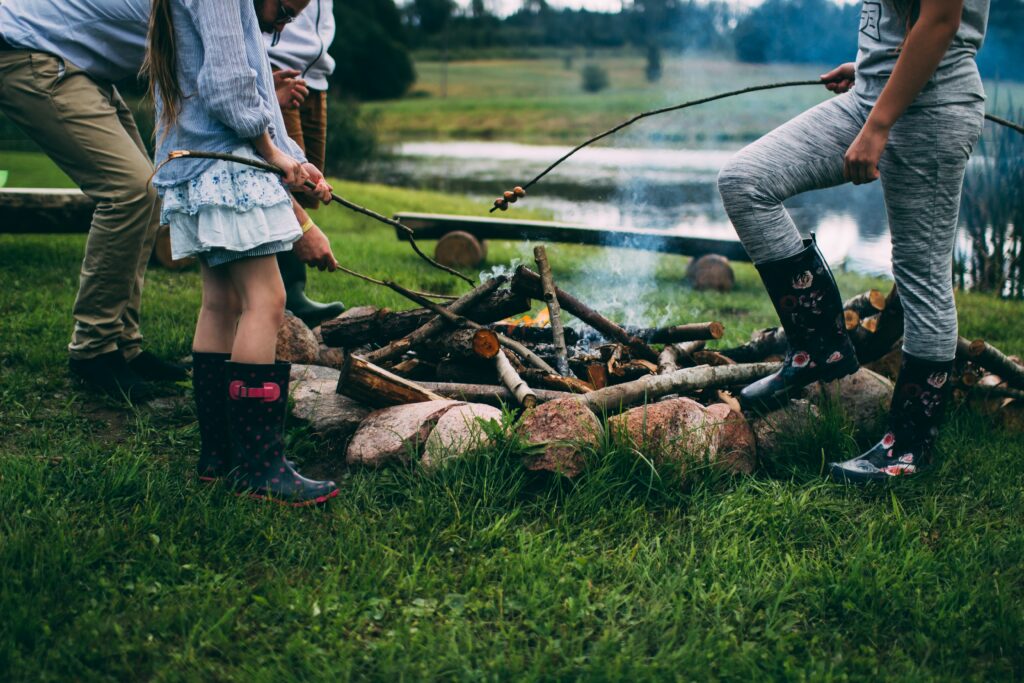 A Family Roasting Marshmallows on a Campfire